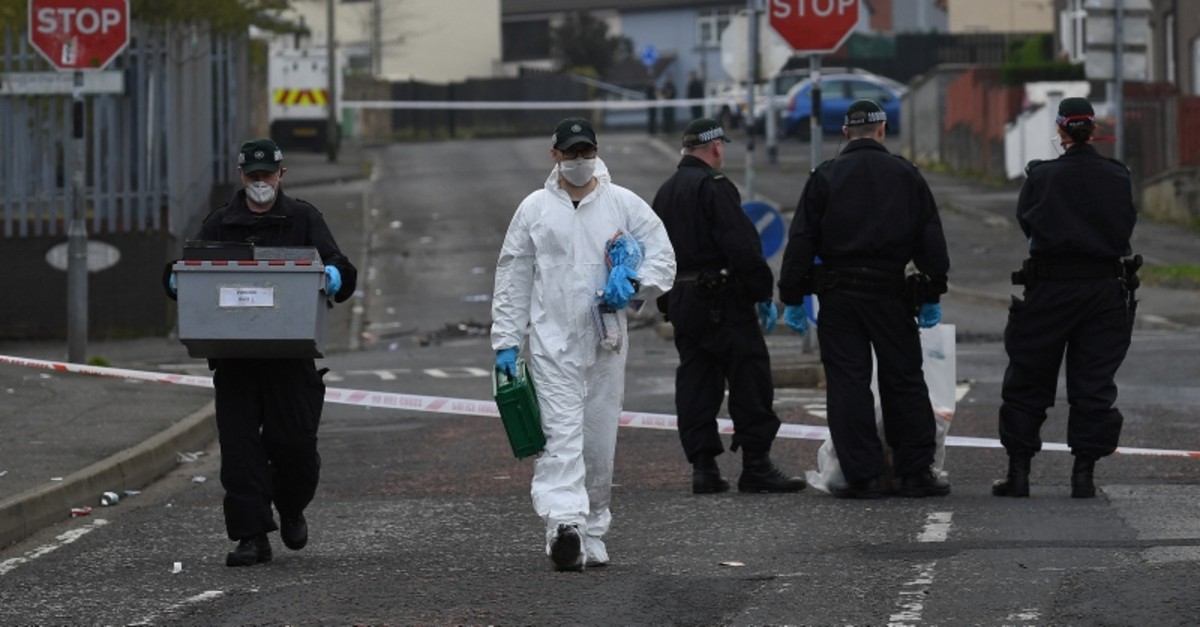 Police officers carry a box of evidence as they leave the scene where the 29-year-old journalist Lyra McKee was shot dead, in Londonderry, Northern Ireland April 19, 2019. (Reuters Photo)