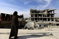 A woman hangs laundry in Raqqa, Syria, Jan. 11.