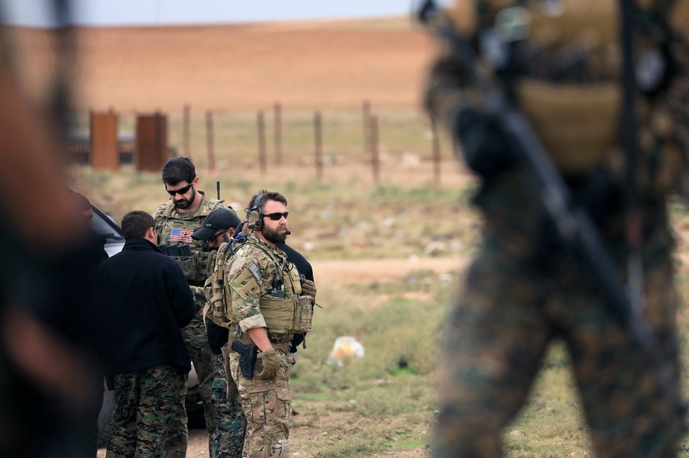 Members of the Syrian Democratic Forces (SDF) and U.S. troops are seen during a patrol near the Turkish border in Syria's Hasakah province, Nov. 4. 