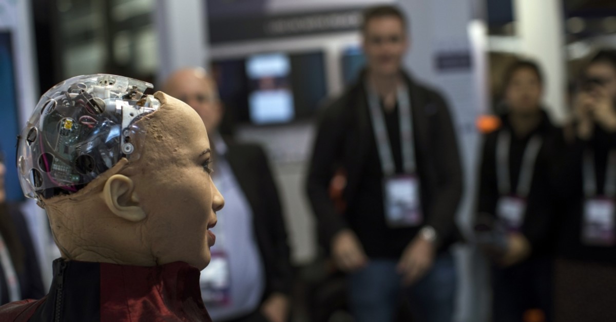 Hanson Robotics' flagship robot Sophia, a lifelike robot powered by artificial intelligence, speaks with visitors at the Mobile World Congress wireless show, in Barcelona, Spain, Feb. 26, 2019. 
