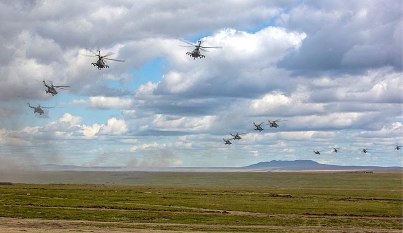In this photo provided by Russian Defense Ministry Press Service on Tuesday, Sept. 11, 2018, Russian military helicopters fly, in the Chita region, Eastern Siberia, during the Vostok-2018 exercises in Russia. (AP Photo)
