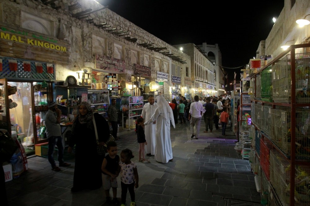 People walk at the Souq Waqif market in Doha days after Gulf nations cut diplomatic ties with Qatar, June 9.