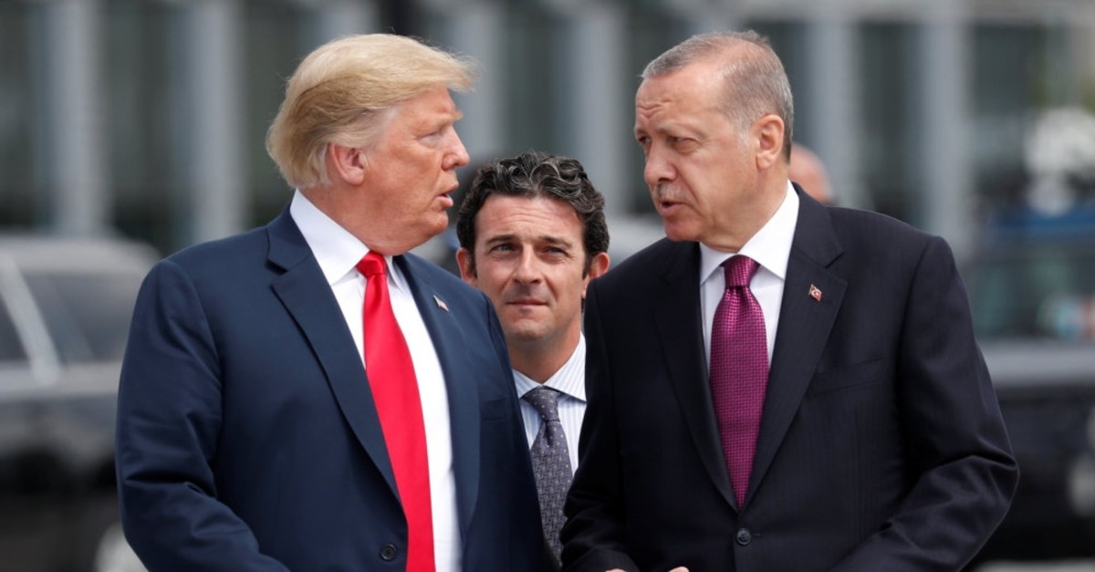 President Recep Tayyip Erdou011fan and U.S. President Donald Trump walk as they talk at the start of the NATO summit in Brussels, Belgium, July 11, 2018. 