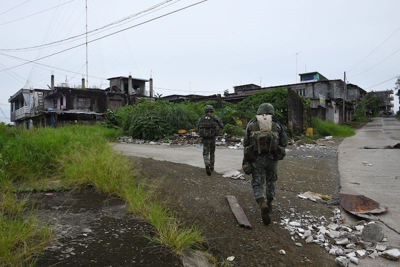 Philippine troops patrolling a deserted neighborhood in Marawi City in July 2017. AFP Photo