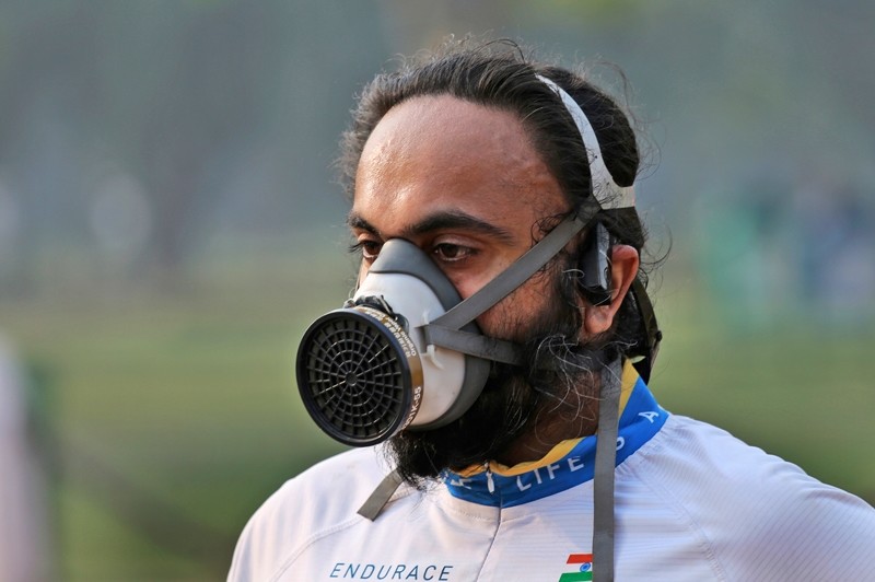 A participant wears a mask as he runs during the Delhi Half Marathon in New Delhi, India ( AP Photo)