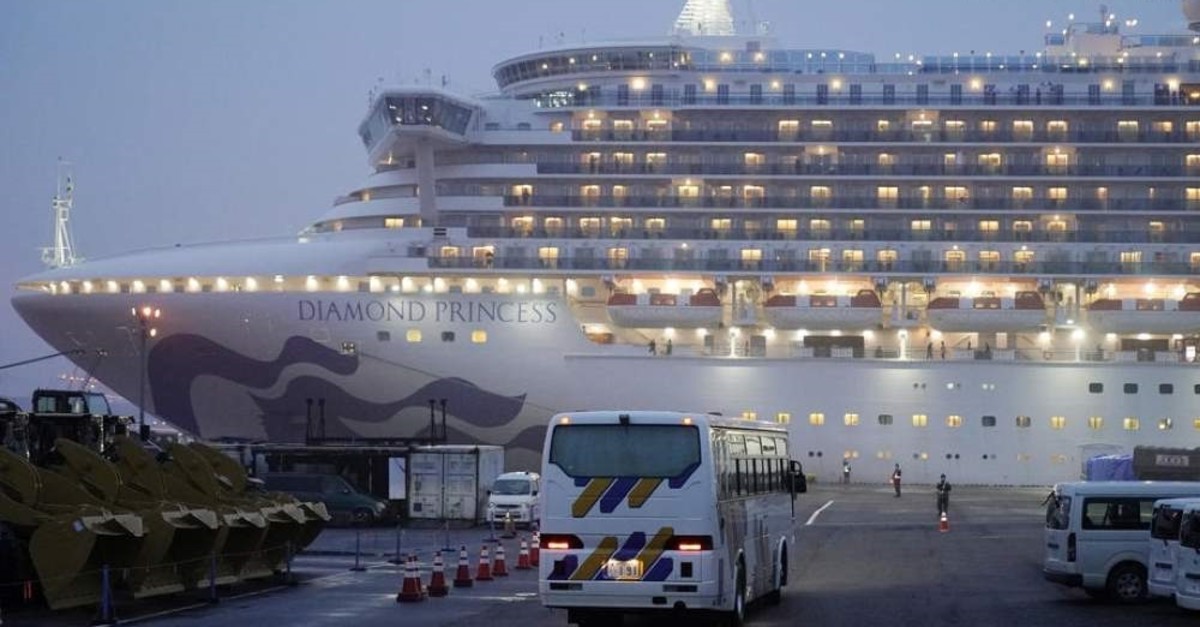 Buses with closed curtains arrive at the Daikoku Pier Cruise Terminal where the Diamond Princess cruise ship is docked, Yokohama, Feb. 16, 2020. (EPA Photo)